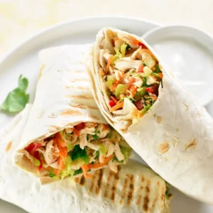 Lebanese sandwich wraps filled with marinated chicken, spiced lamb, or falafel, served with crispy chips and fresh salad.