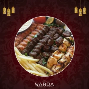 A Platter Of Grilled Meat Skewers Including Lamb Kafta, Taouk, Lahim Meshoué, And Chicken Kafta, Served With Fragrant Rice.